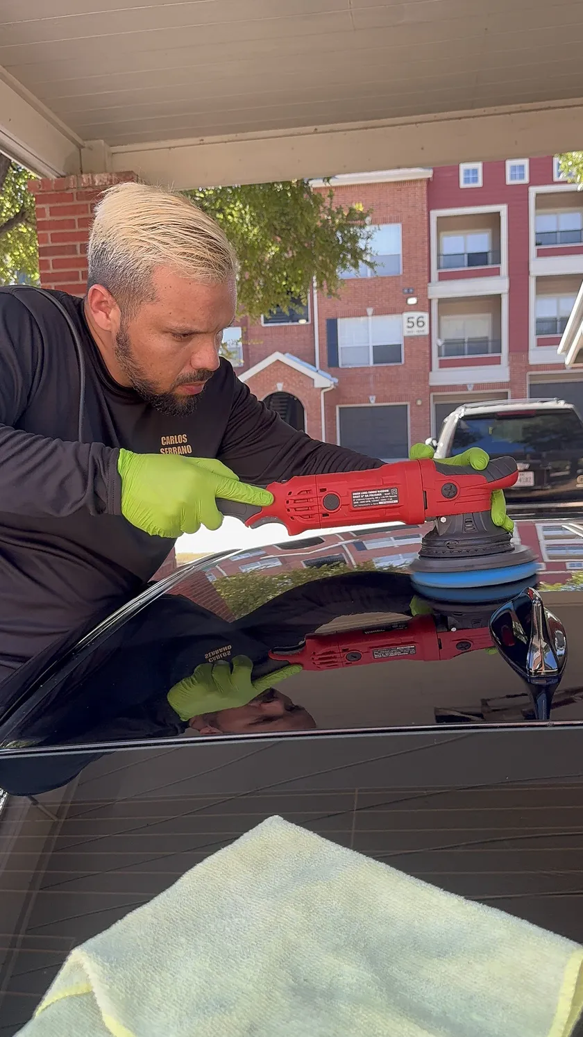 Carlos Serrano, founder of Supreme Box Detail, performing paint correction in Fort Worth